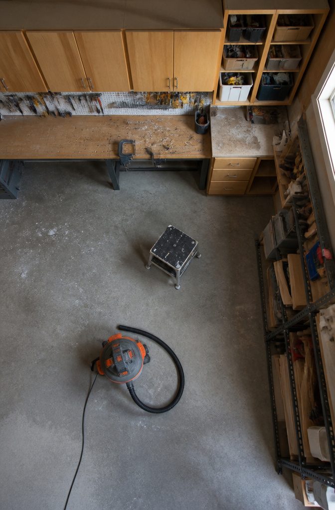 Garage upper cabinets with closed doors above a workbench