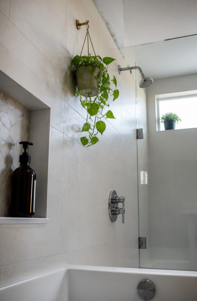 How to Hang a Plant in the Shower: 5 Steps 4 Pothos planter suspended from a wall hook above a bathtub