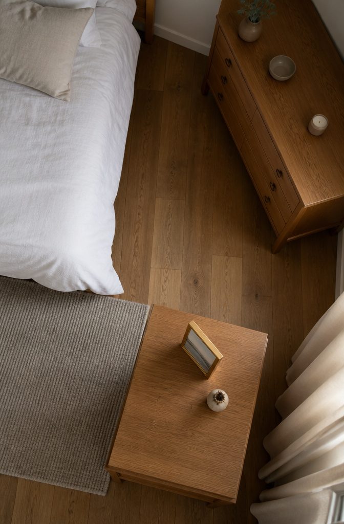 Bedroom dresser top with a picture frame and one personal object