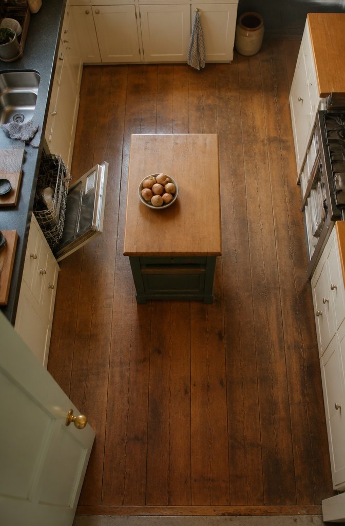 Kitchen island with open walkways between surrounding cabinets